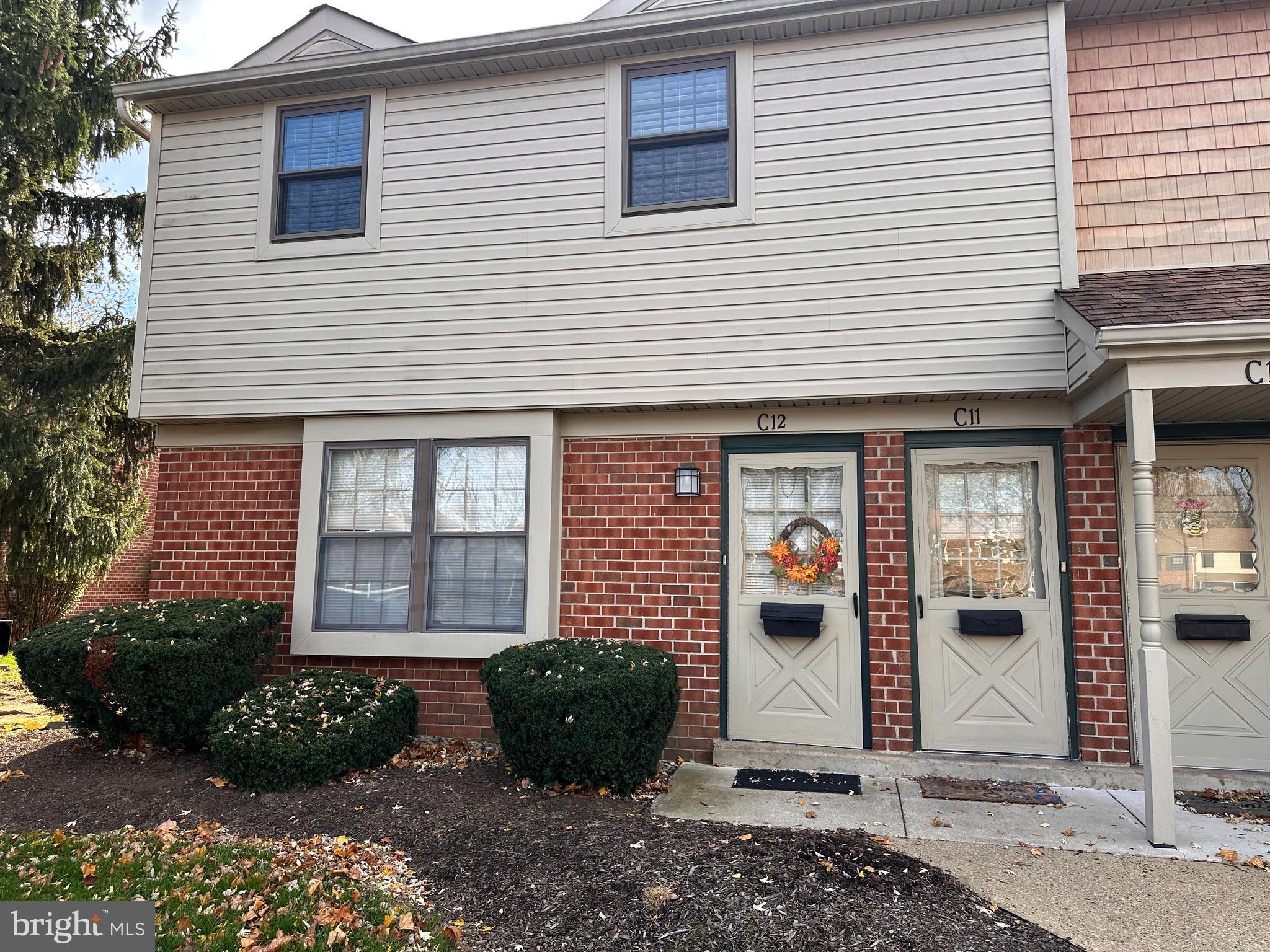 a view of a brick house with many windows
