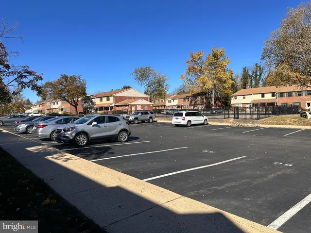 a view of a cars parked on the side of a street