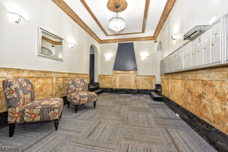 303 Hamilton Place, Unit A4 Hackensack, NJ 07601 - Photo 12 of 13 a view of hallway with couch and chandelier