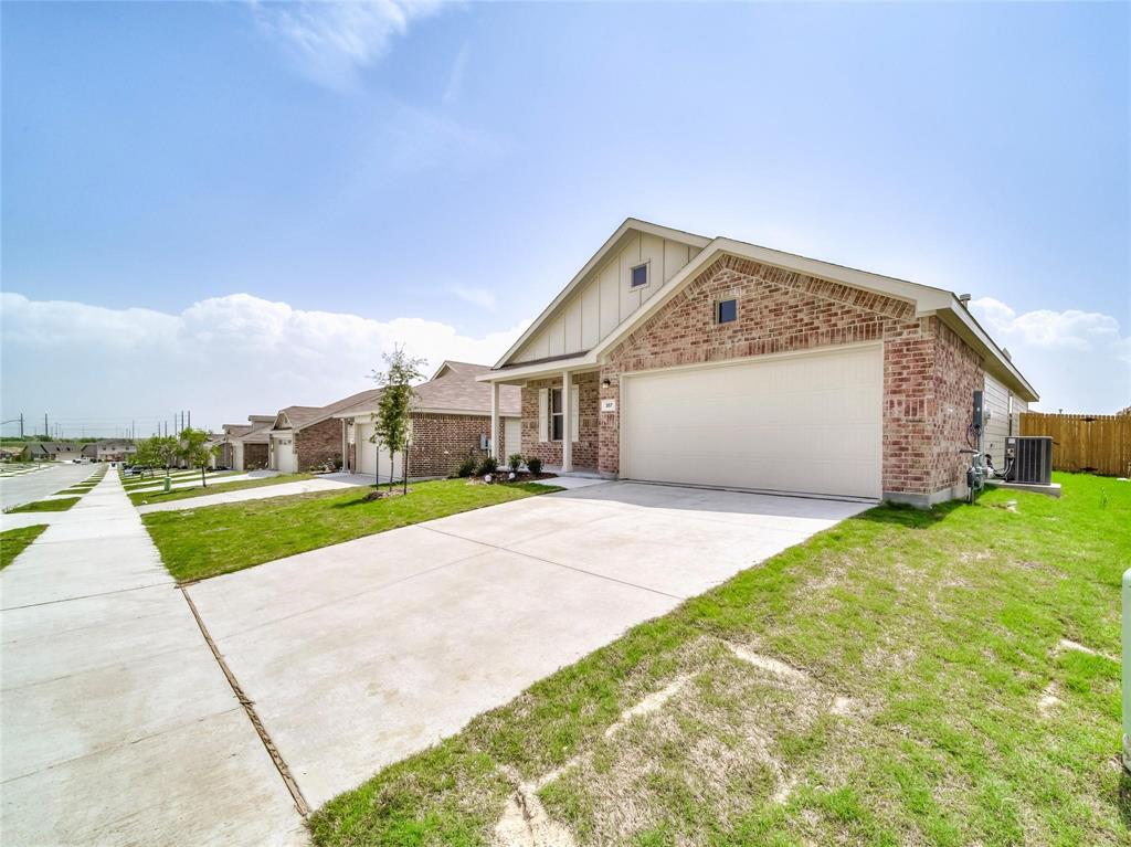 357 Sun Bluff Road Fort Worth, TX 76052 - Photo 20 of 35 Brick exterior with light siding accents, an attached garage, a concrete driveway, and a fenced backyard