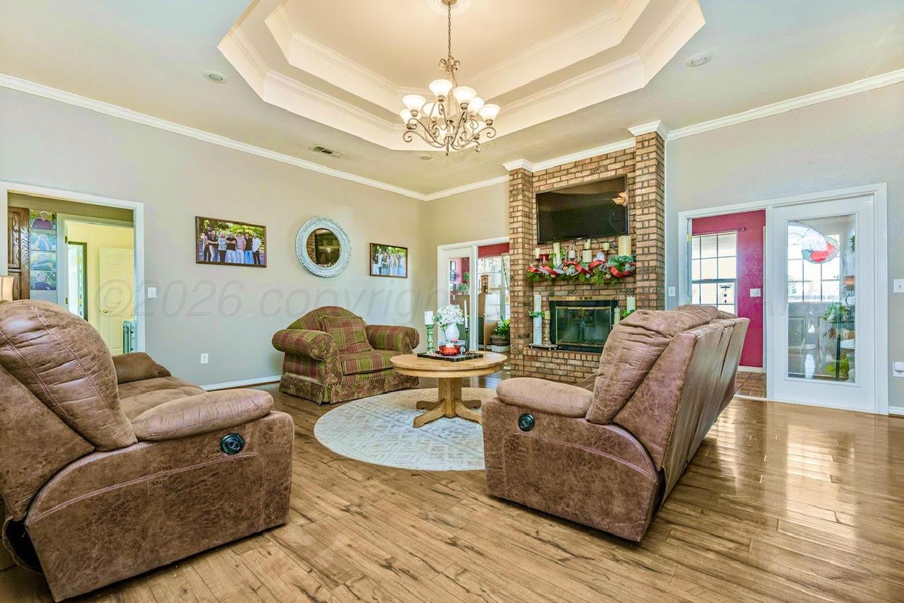 200 Hunters Trail Amarillo, TX 79124 - Photo 4 of 23 a living room with fireplace furniture and a chandelier