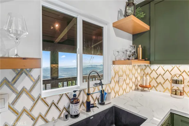 a living room with furniture kitchen view and a large window
