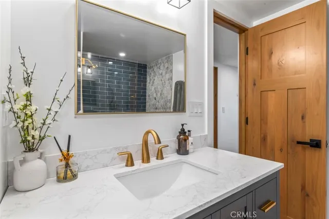 a bathroom with a sink and mirror