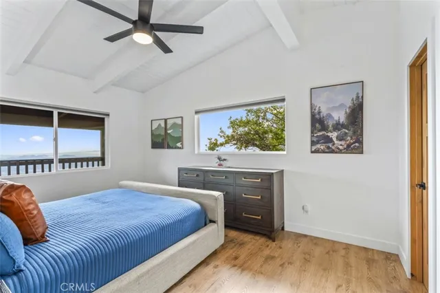 a bedroom with a bed and a flat tv screen