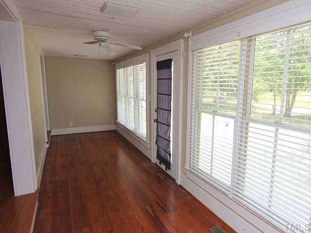 6422 Efland - Cedar Grove Road Cedar Grove, NC 27231 - Photo 11 of 12 a view of an empty room with wooden floor and a window