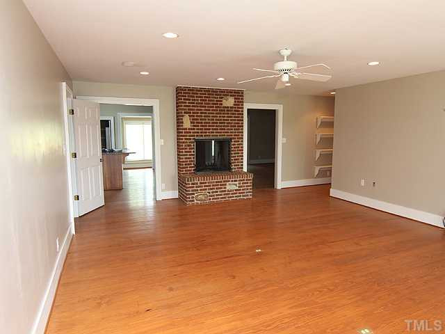 6422 Efland - Cedar Grove Road Cedar Grove, NC 27231 - Photo 2 of 12 wooden floor in an empty room with a fireplace