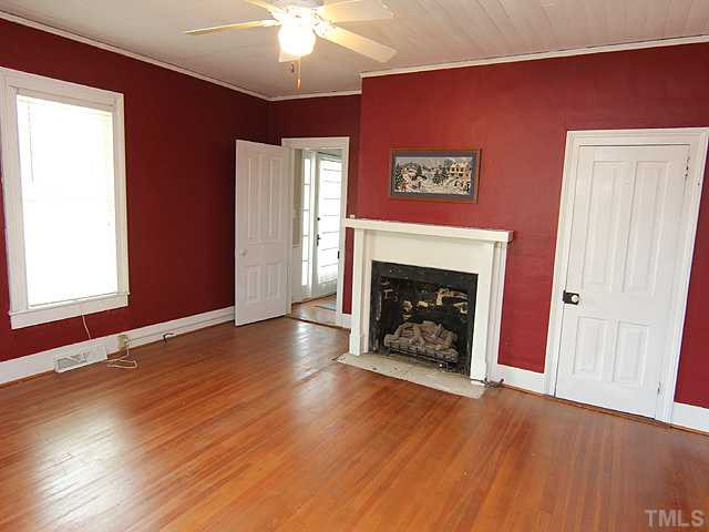 6422 Efland - Cedar Grove Road Cedar Grove, NC 27231 - Photo 4 of 12 a view of a livingroom with a fireplace wooden floor and window