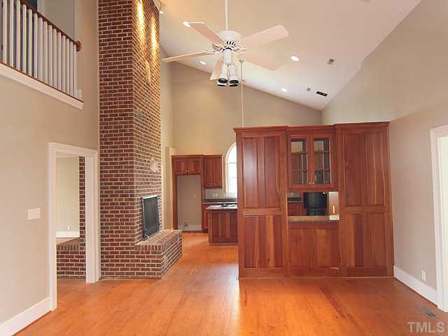 6422 Efland - Cedar Grove Road Cedar Grove, NC 27231 - Photo 5 of 12 a view of a kitchen with wooden floor and a refrigerator