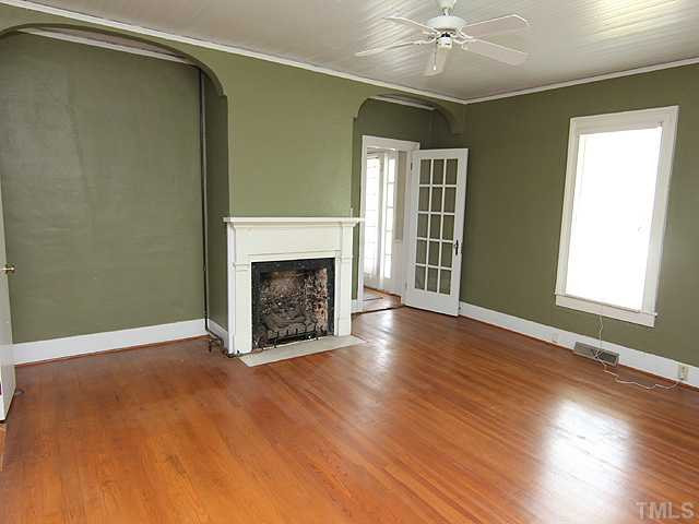 6422 Efland - Cedar Grove Road Cedar Grove, NC 27231 - Photo 7 of 12 a view of an empty room with a fireplace and a window