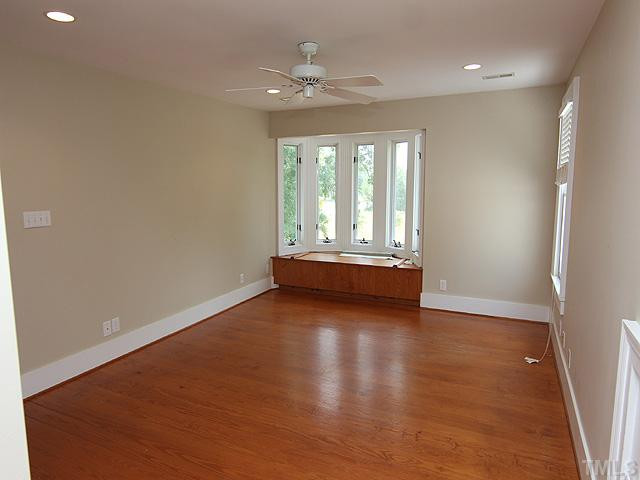 6422 Efland - Cedar Grove Road Cedar Grove, NC 27231 - Photo 9 of 12 an empty room with wooden floor and windows
