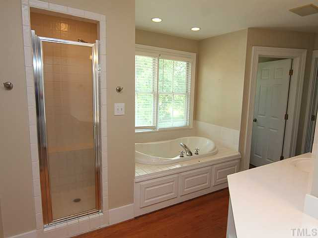 6422 Efland - Cedar Grove Road Cedar Grove, NC 27231 - Photo 10 of 12 a bathroom with a tub a sink and a window