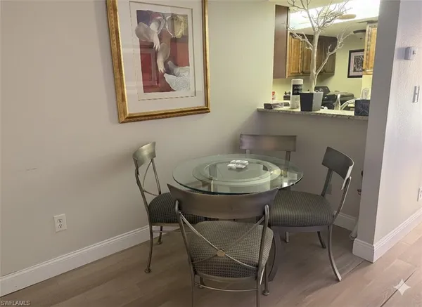 a view of a dining room with furniture and wooden floor