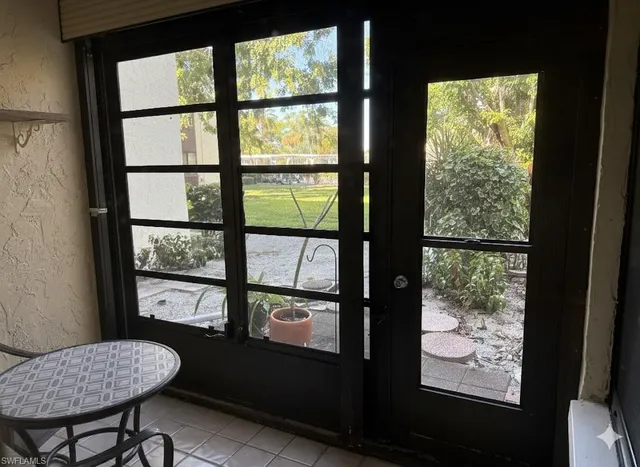 a view of a room with furniture and a window