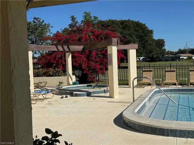 a view of a swimming pool with a couches and lounge chair