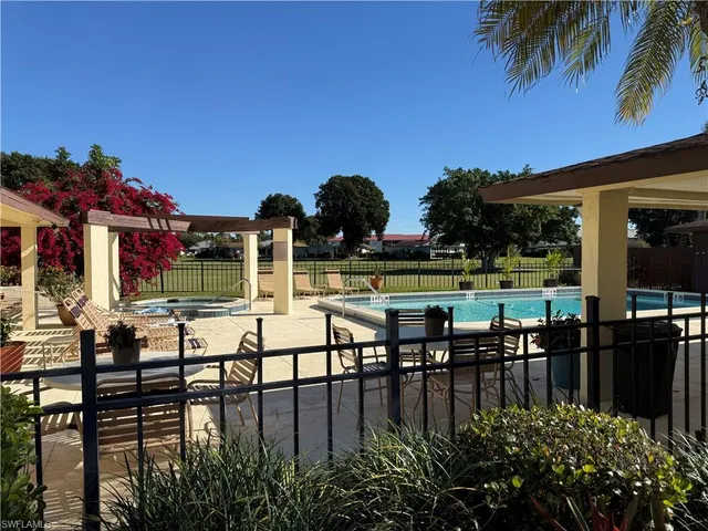 a view of a lake with a table and chairs