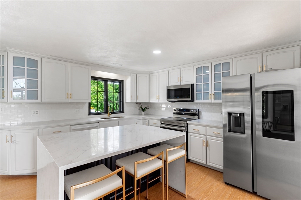 4 Blacksmith Way Saugus, MA 01906 - Photo 11 of 42 a kitchen with stainless steel appliances a microwave sink and refrigerator