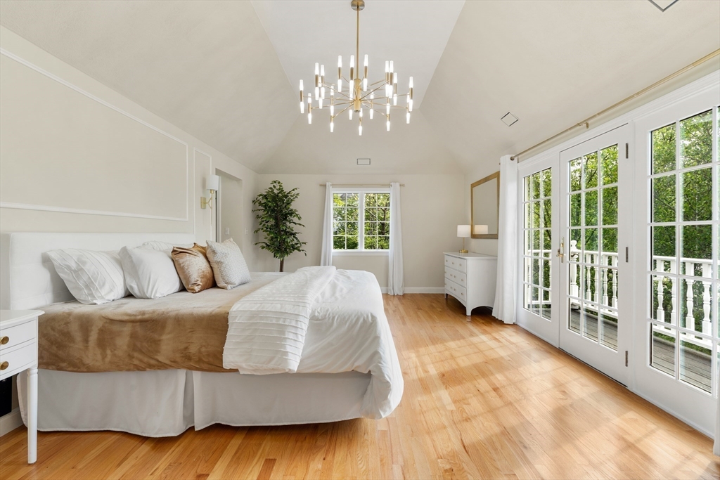 4 Blacksmith Way Saugus, MA 01906 - Photo 13 of 42 a spacious bedroom with a large bed and a chandelier