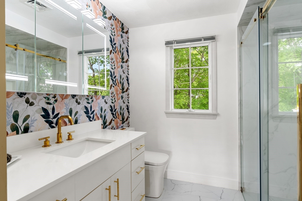4 Blacksmith Way Saugus, MA 01906 - Photo 20 of 42 a bathroom with a sink mirror and window