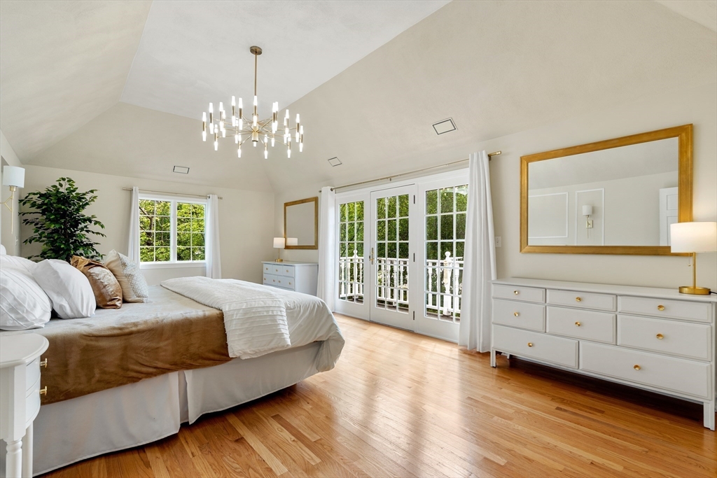 4 Blacksmith Way Saugus, MA 01906 - Photo 2 of 42 a spacious bedroom with a large bed and a chandelier