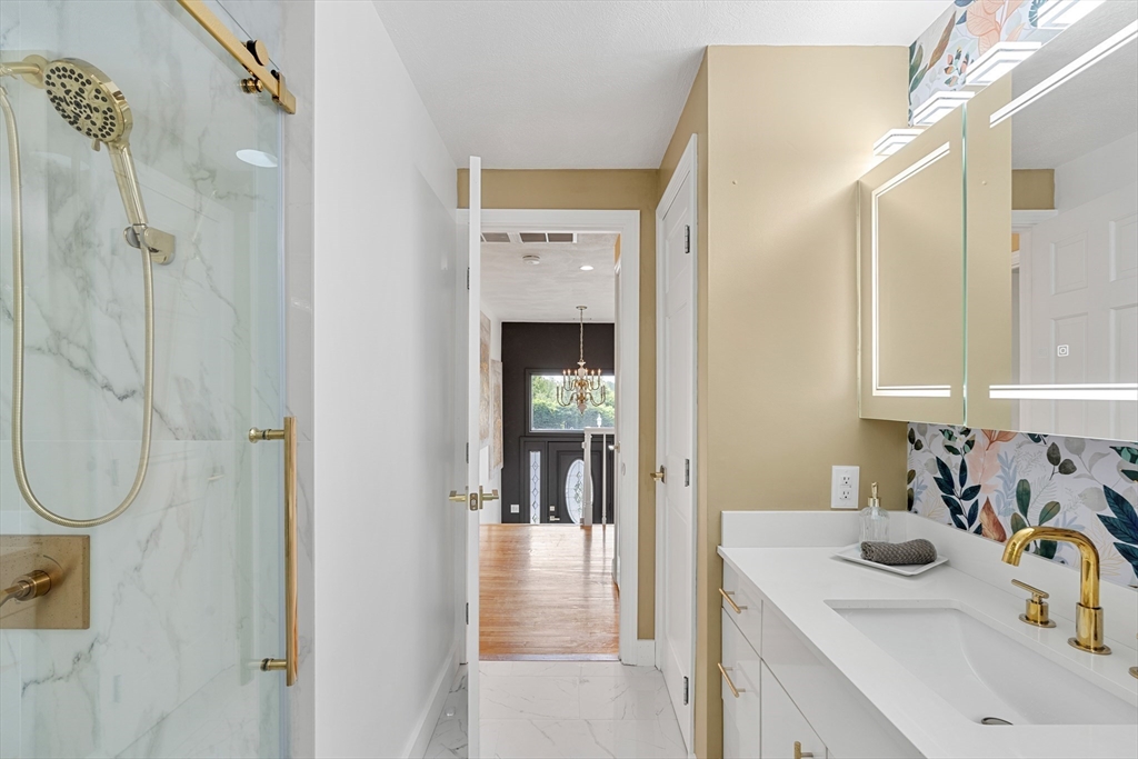 4 Blacksmith Way Saugus, MA 01906 - Photo 21 of 42 a bathroom with a sink vanity mirror and shower