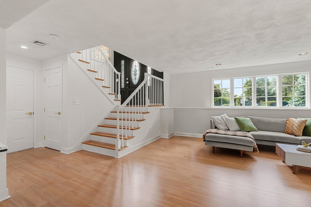 4 Blacksmith Way Saugus, MA 01906 - Photo 22 of 42 a living room with furniture and stairs