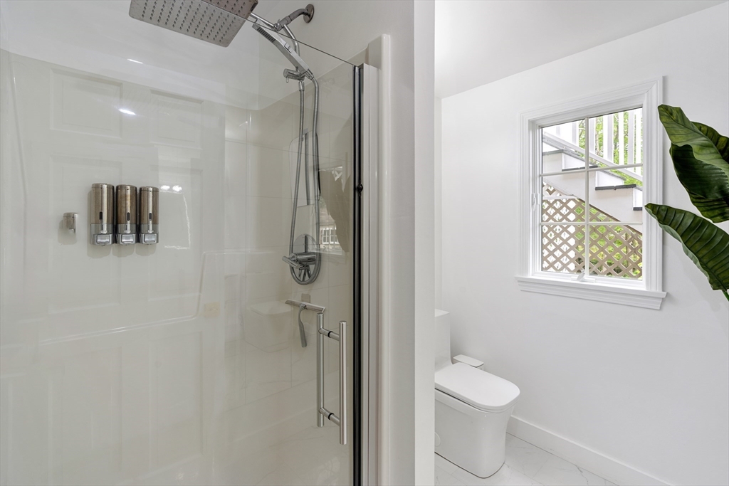 4 Blacksmith Way Saugus, MA 01906 - Photo 29 of 42 a bathroom with a shower a toilet and a sink