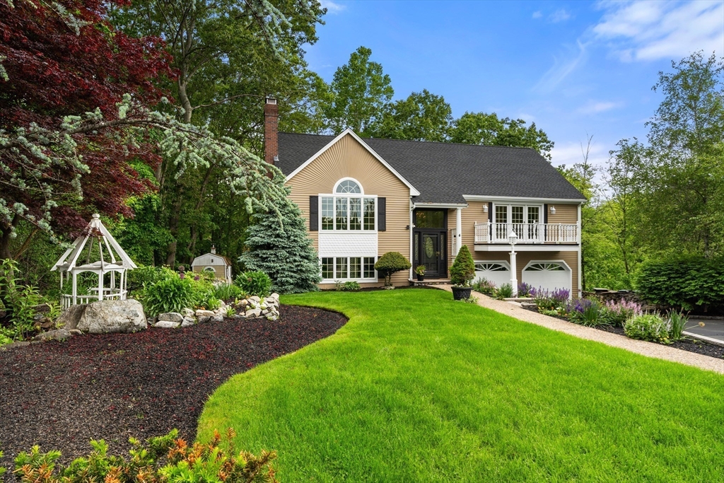 4 Blacksmith Way Saugus, MA 01906 - Photo 3 of 42 a front view of a house with a garden and trees