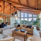 a living room with furniture a fireplace and a large window