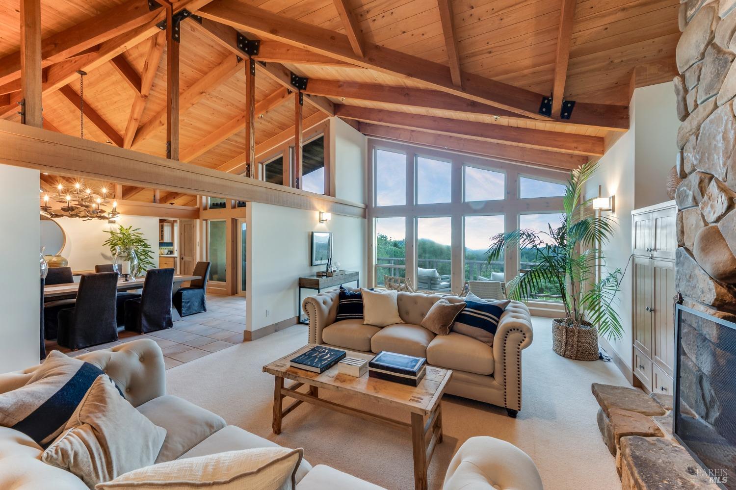 a living room with furniture a fireplace and a large window