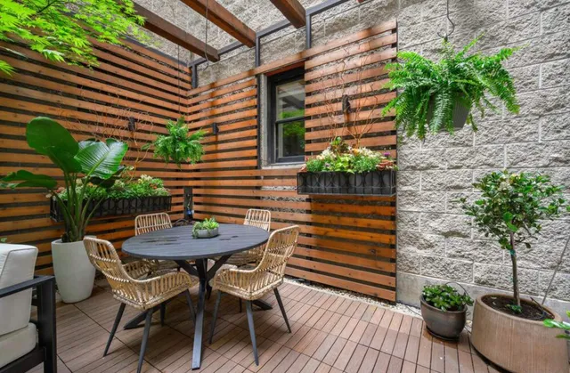 a view of a wooden bench in patio of a house