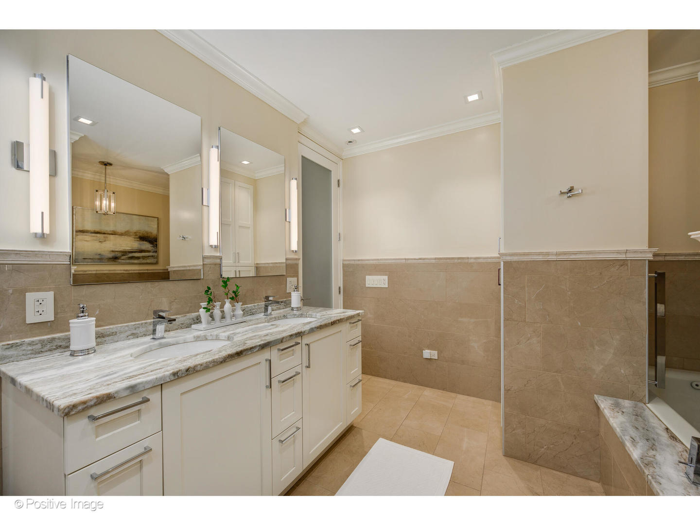 1112 North Dearborn Street, Unit 1 Chicago, IL 60610 - Photo 23 of 34 a bathroom with a granite countertop sink a mirror and a shower