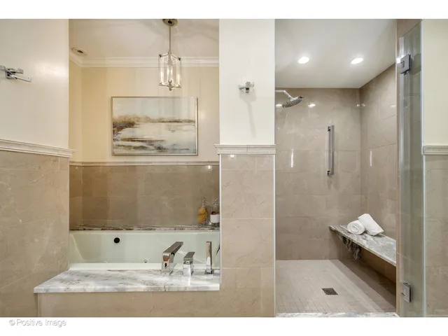 a bathroom with a tub shower and sink