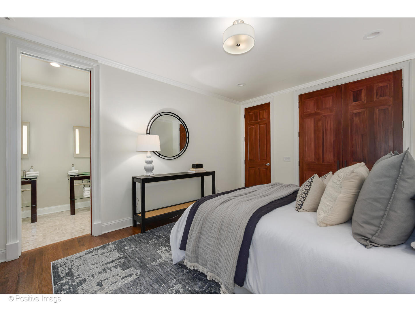 1112 North Dearborn Street, Unit 1 Chicago, IL 60610 - Photo 26 of 34 a bedroom with a bed a mirror and desk