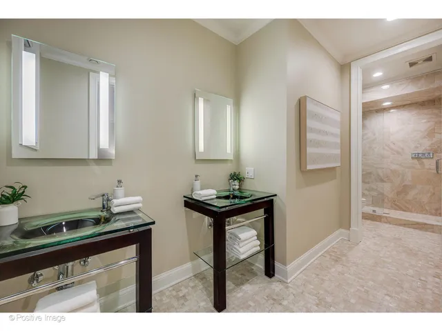 a kitchen with granite countertop a sink cabinets and a wooden floor