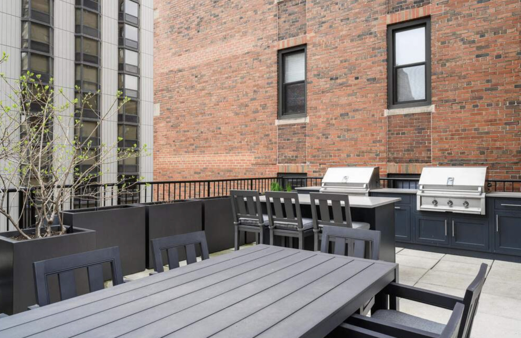 1112 North Dearborn Street, Unit 1 Chicago, IL 60610 - Photo 32 of 34 a balcony view with a wooden table and chairs