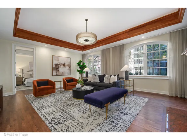 a living room with furniture chandelier and a window