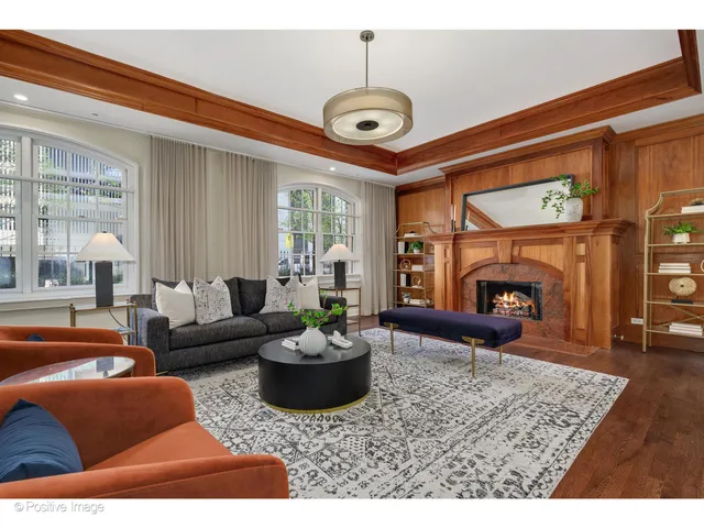 a living room with furniture a fireplace and a large window