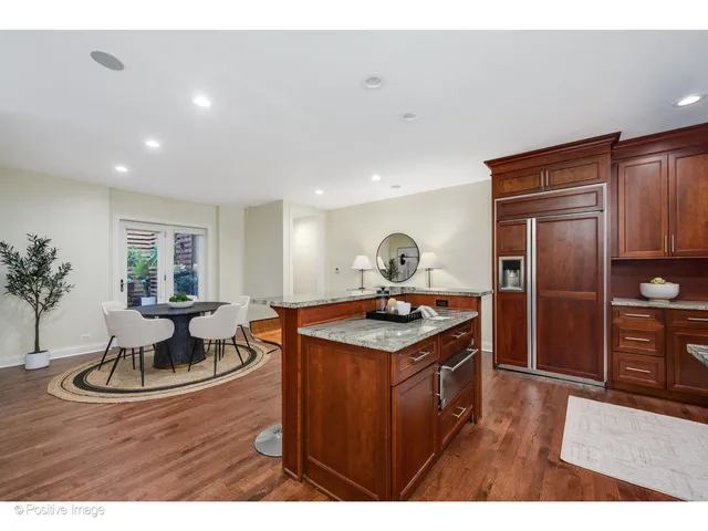 a kitchen with a stove a refrigerator and a dining table