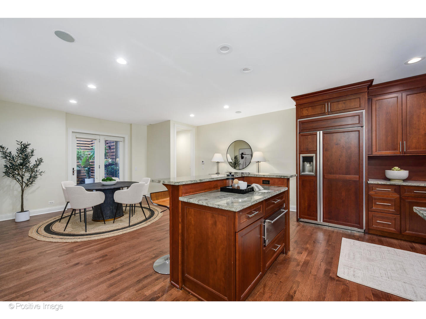 1112 North Dearborn Street, Unit 1 Chicago, IL 60610 - Photo 8 of 34 a kitchen with a stove a refrigerator and a dining table