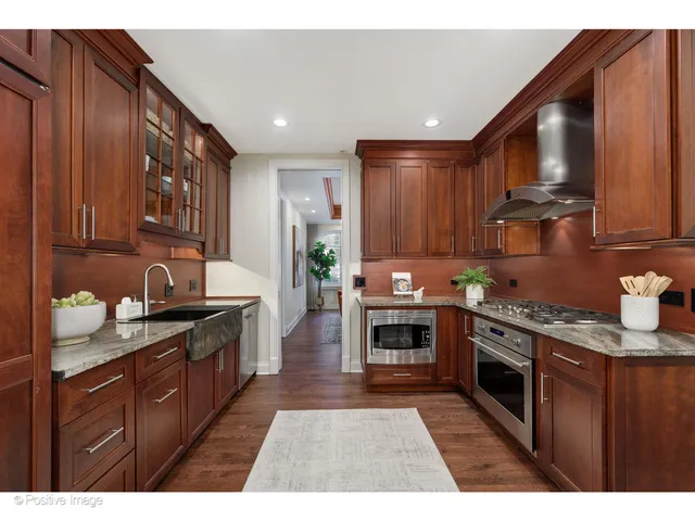 a kitchen with stainless steel appliances granite countertop a stove sink and cabinets