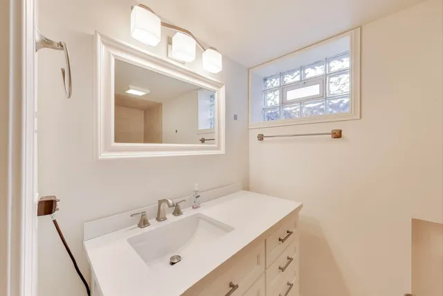 a bathroom with a sink and a mirror