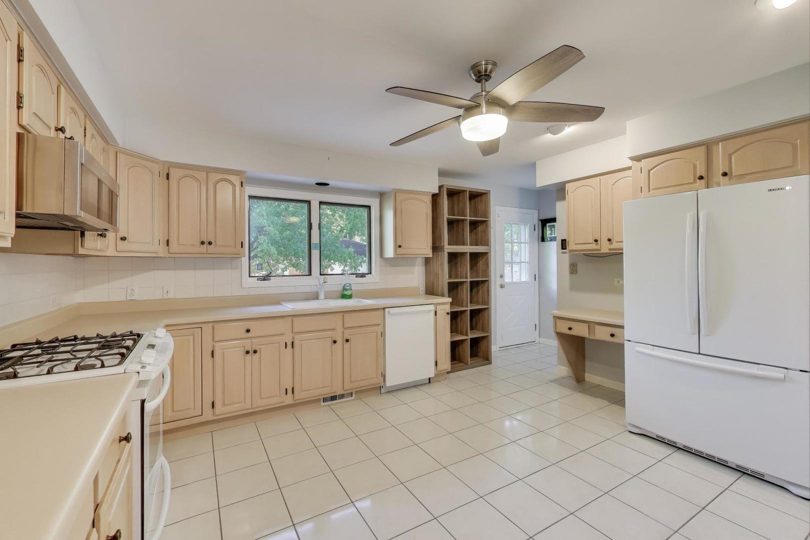 927 Half Day Road Highland Park, IL 60035 - Photo 6 of 20 a kitchen with white cabinets and white appliances