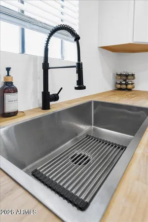 a kitchen with a sink and stainless steel appliances