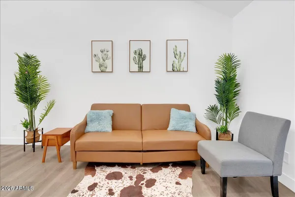 a living room with furniture and a potted plant