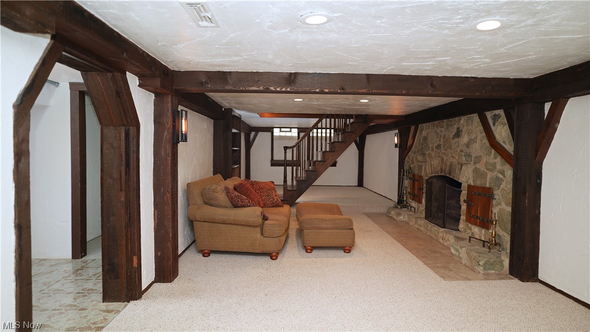 6676 Rochelle Boulevard Parma Heights, OH 44130 - Photo 16 of 21 Unfurnished living room with a stone fireplace and light carpet