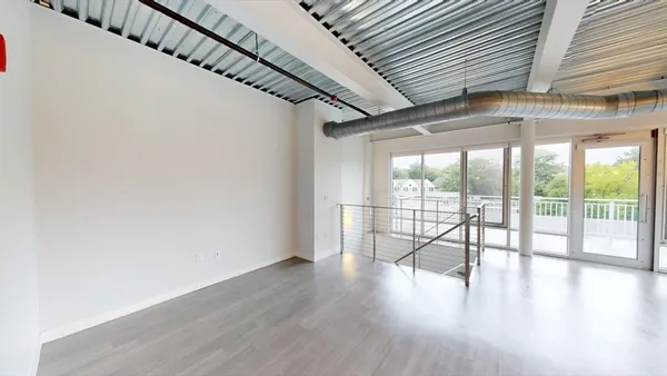 a view of an entryway with wooden floor