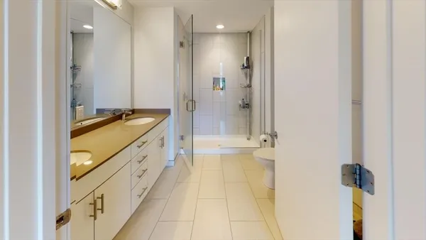 a bathroom with a granite countertop sink a mirror and a bathtub