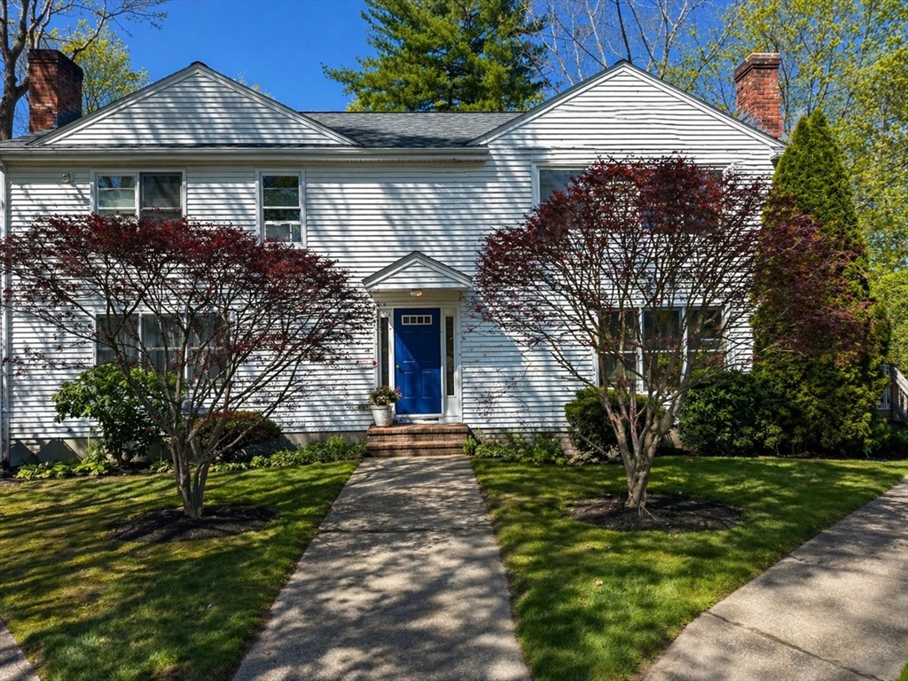 a front view of a house with a garden