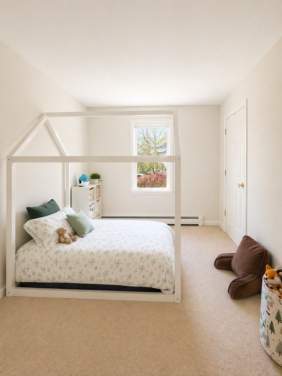 4 Westview Terrace, Unit 4 Natick, MA 01760 - Photo 7 of 9 a bedroom with a bed and window