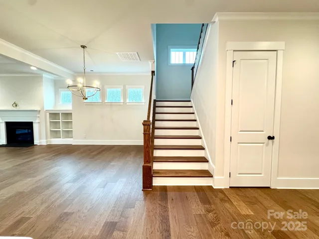 a view of a room with wooden floor and fireplace
